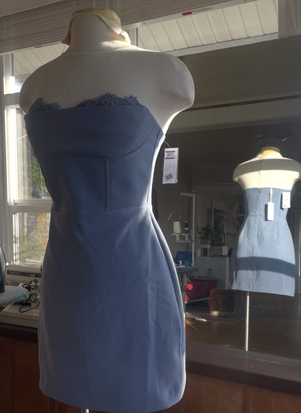 Cornflower blue strapless dress on a dress form