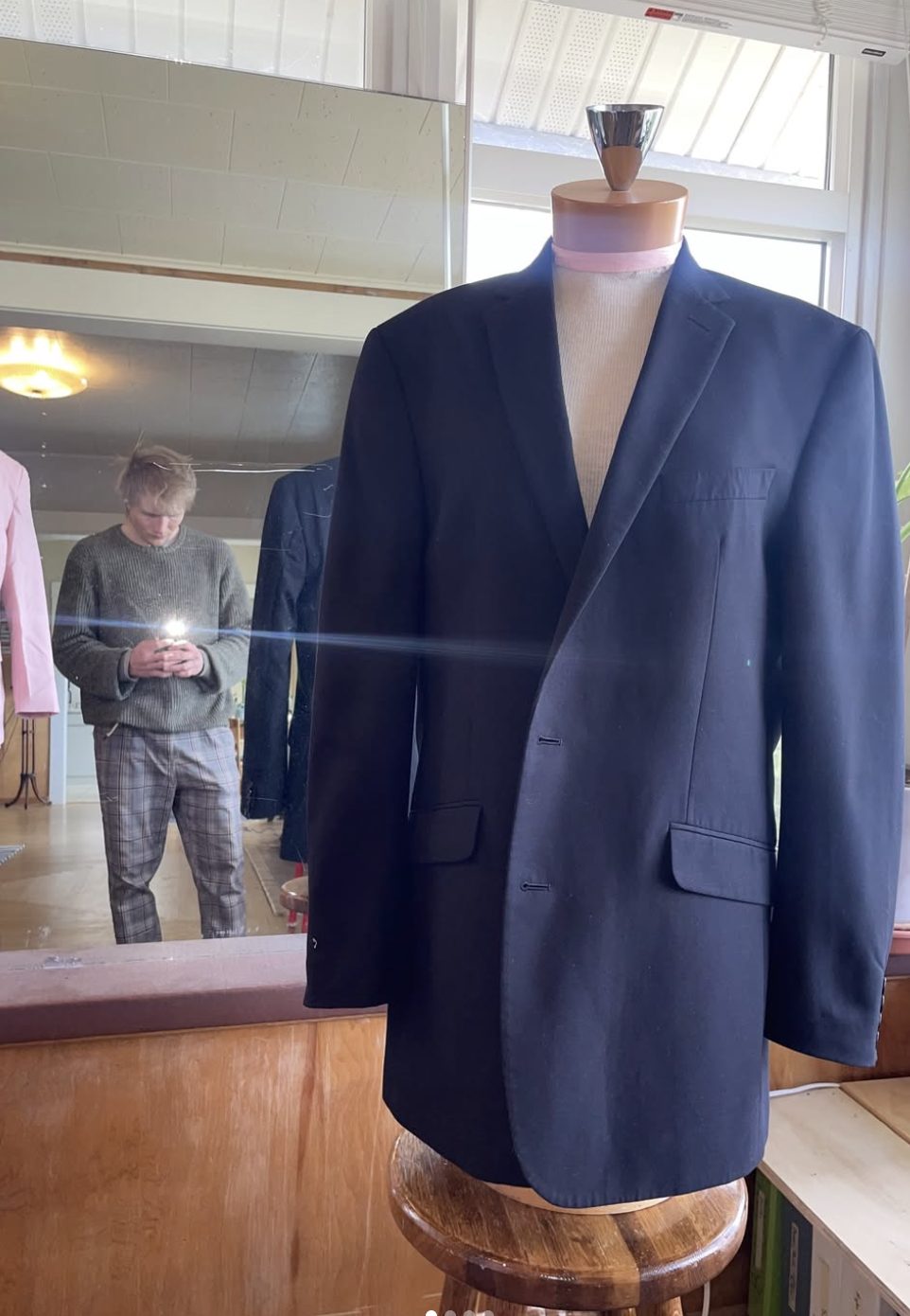 Navy wool suit jacket on a tailor's form